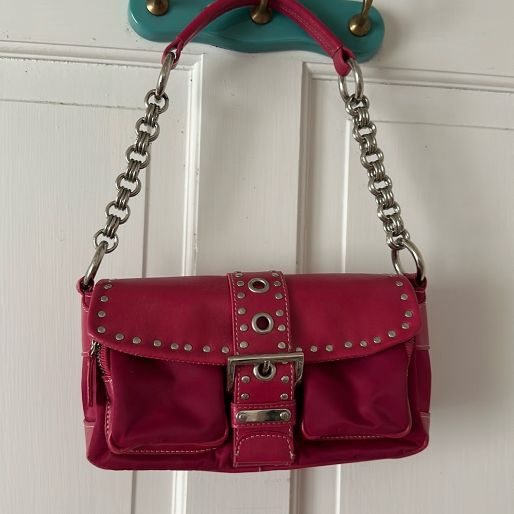 Small pink purse with grommets and buckle detail
